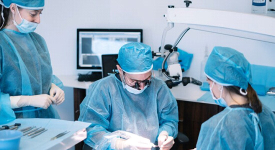 dentist peforming a dental implant surgery