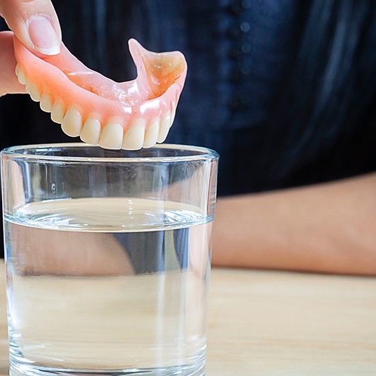 Patient in Grand Island about to soak their dentures