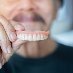  Patient in Grand Island taking out their dentures