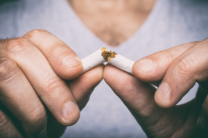 Close up of man breaking a cigarette in half