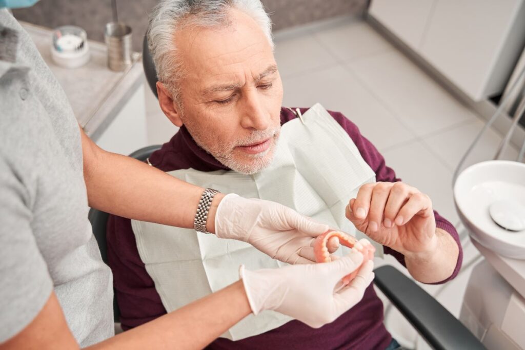 A man getting a new pair of dentures at the dentist.